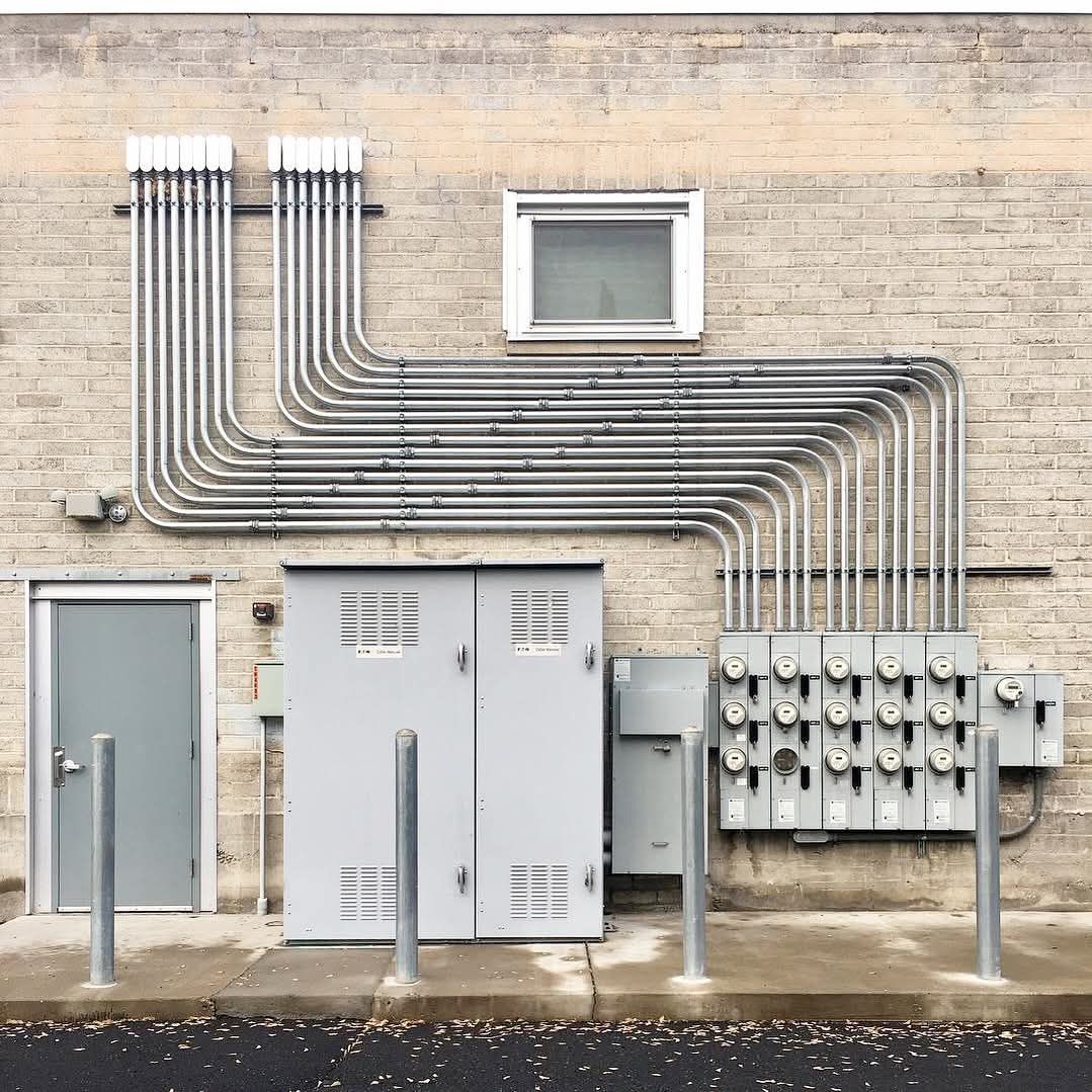 Exterior electrical meters, equipment and neatly routed metal conduit